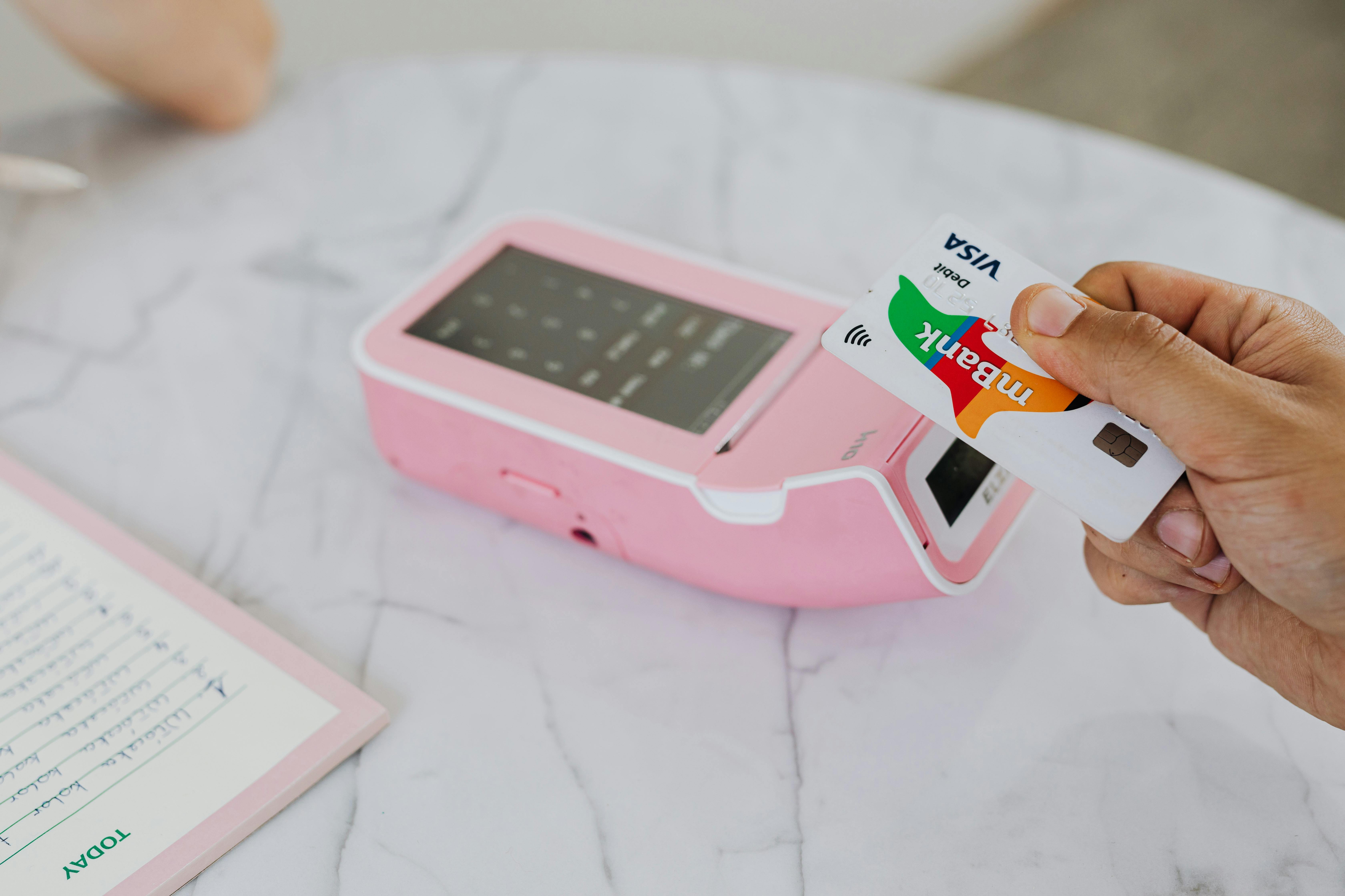 Customer making a contactless payment with a smartphone at a payment terminal