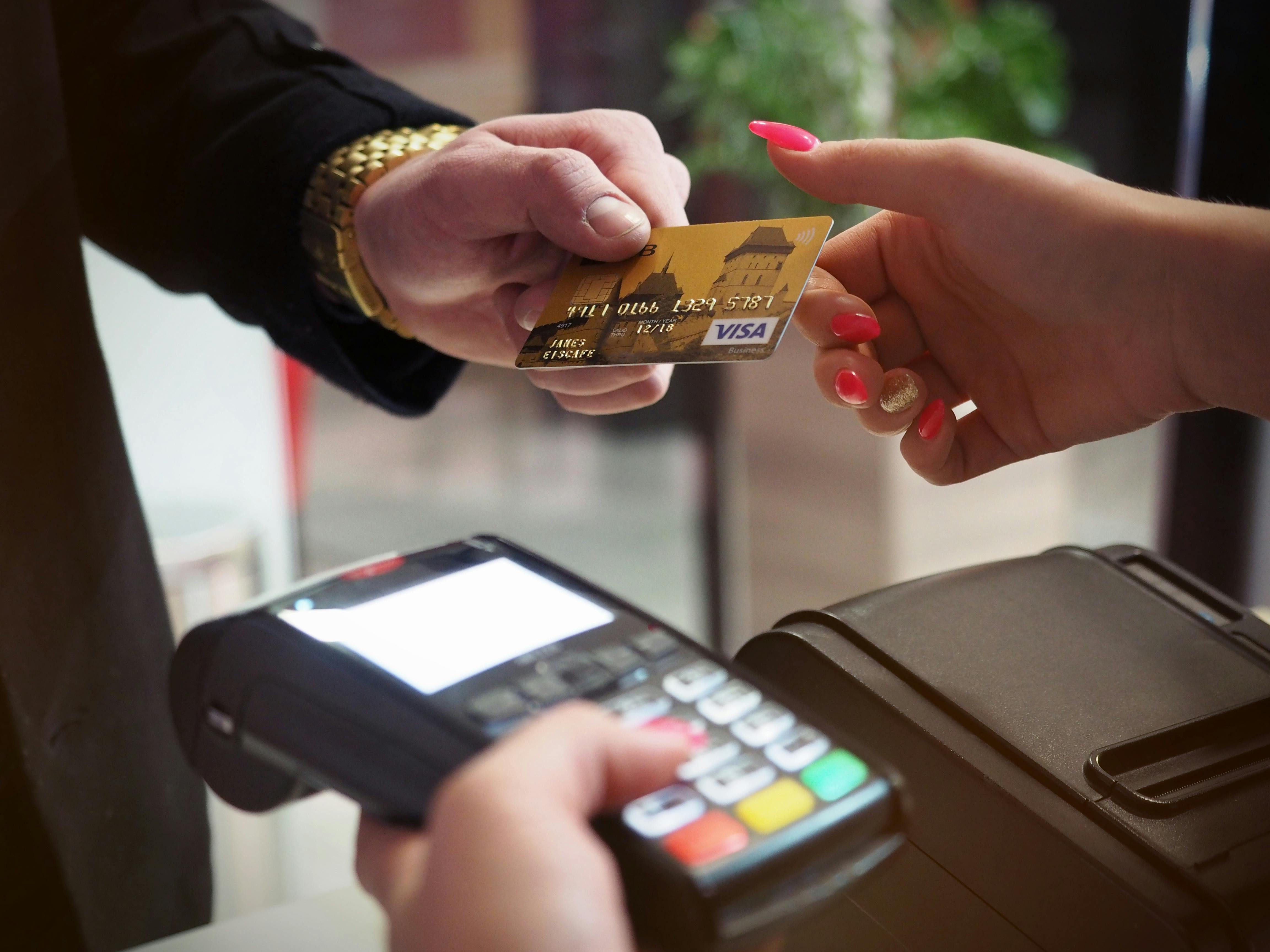 Person shopping online with a credit card and laptop